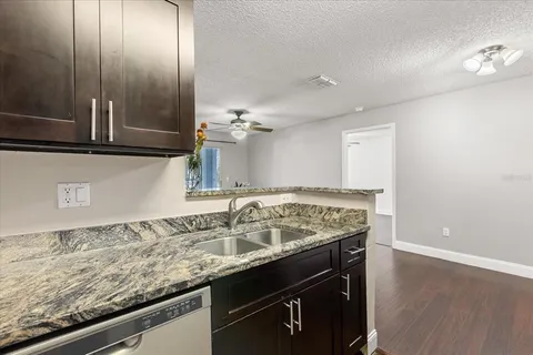 an empty room with wooden floor a ceiling fan and closet