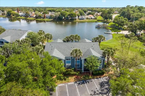 an aerial view of a houses with a lake view