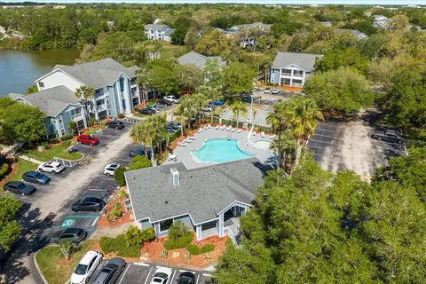 an aerial view of residential houses with outdoor space and parking