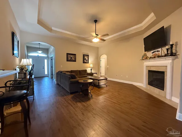 a living room with furniture fireplace and wooden floor