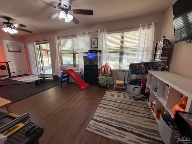 a living room with furniture gym equipment and a large window