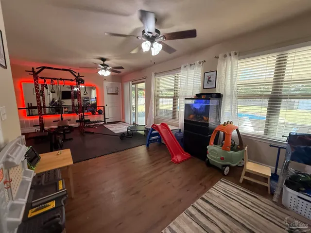 a spacious bedroom with a bed and a chandelier