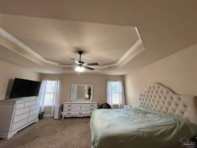 a spacious bathroom with a granite countertop sink a toilet a mirror and shower