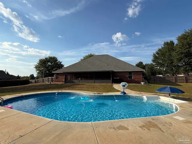 a view of a swimming pool with an outdoor space and seating area