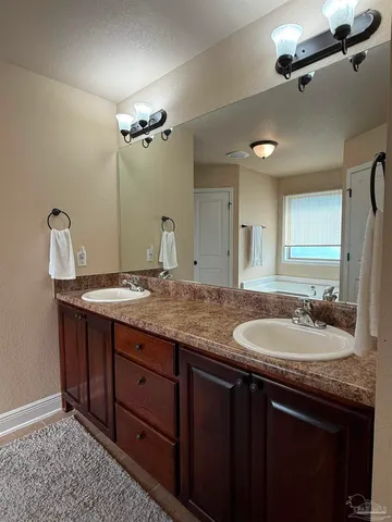 a bathroom with a bathtub and a sink