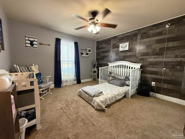 a view of a bedroom with furniture and windows