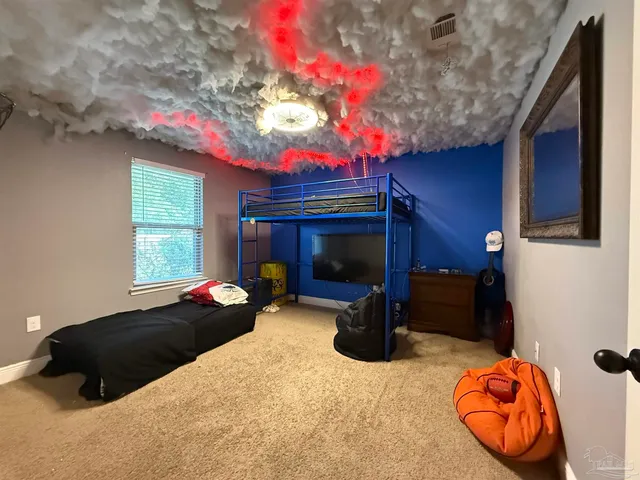 a bedroom with bed and a potted plant