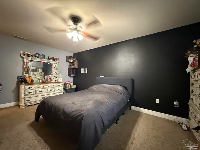 a bathroom with a granite countertop sink a toilet and a mirror