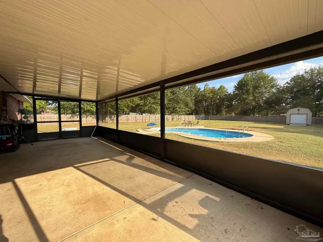 a view of a swimming pool with an outdoor space and seating area