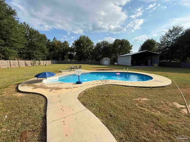a view of a swimming pool and lounge chairs