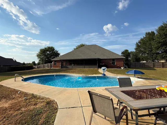 a view of a swimming pool and an outdoor seating