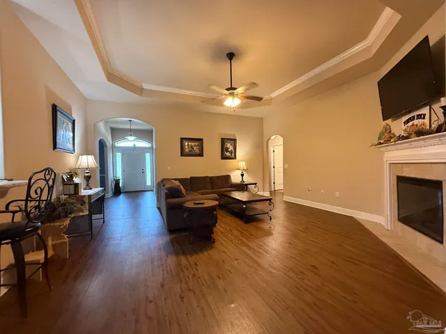 a living room with furniture flat screen tv and fireplace