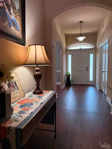 a view of a dining room with furniture wooden floor and chandelier