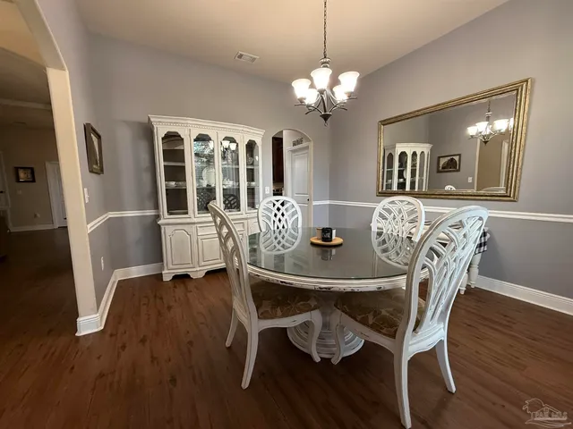 a kitchen with stainless steel appliances granite countertop wooden cabinets a sink dishwasher a stove and a refrigerator