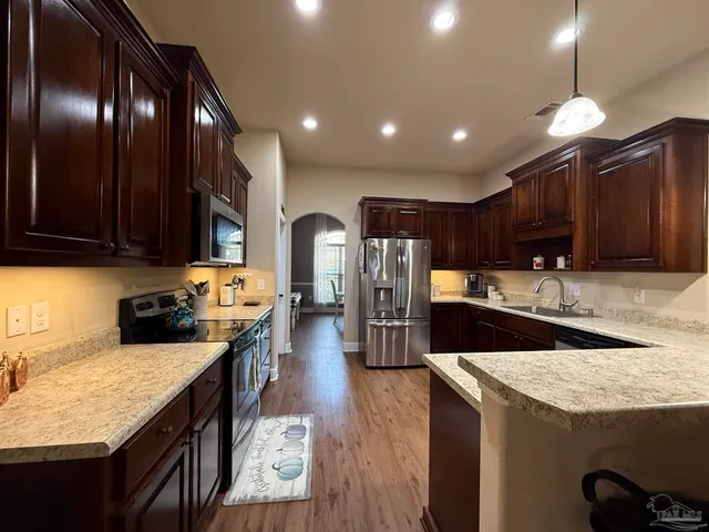 a dining table chairs and a kitchen view