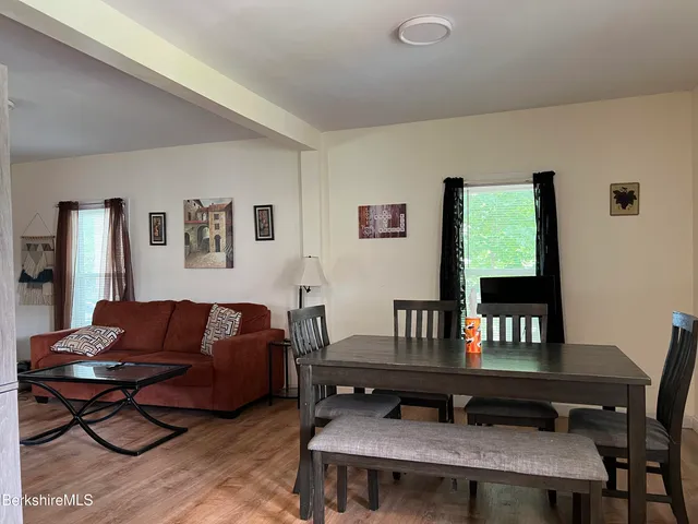 a living room with furniture a table and a window