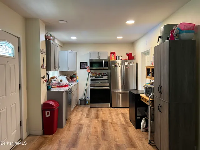 a kitchen with refrigerator and microwave