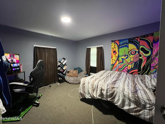 a view of a livingroom with furniture and a flat screen tv