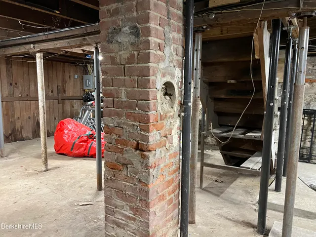 a view of porch with a table and chairs