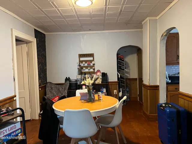 a dining room with furniture and window