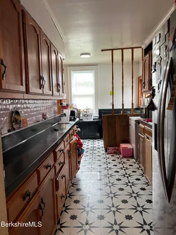 a kitchen with stainless steel appliances a sink stove top oven and cabinets