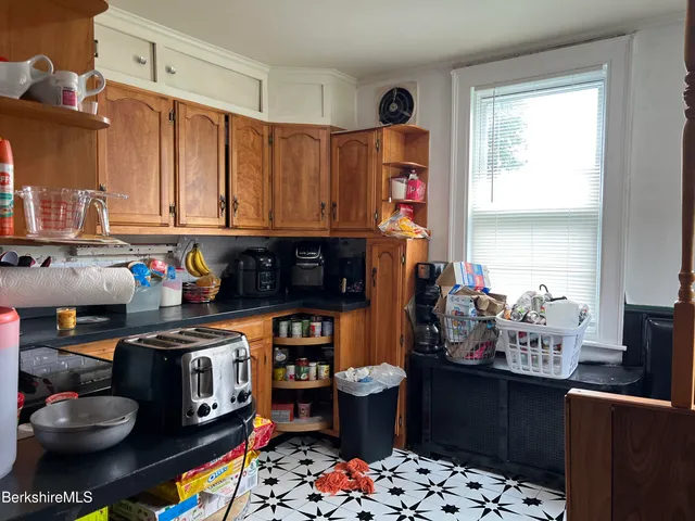 a kitchen with stainless steel appliances a stove a sink and a refrigerator