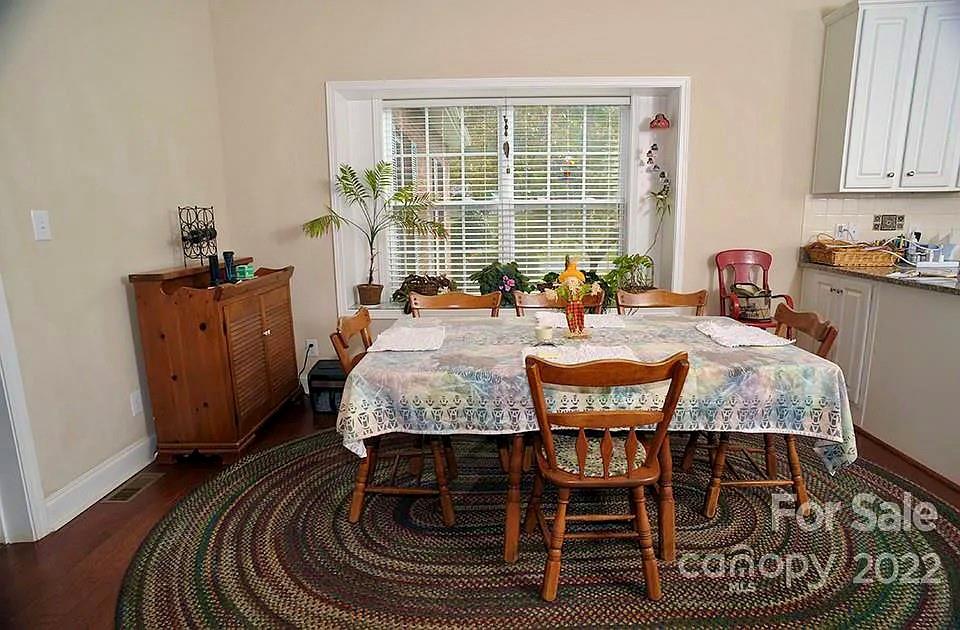 220 Sloan Road Salisbury, NC 28147 - Photo 11 of 30 a dining room with furniture a rug and wooden floor