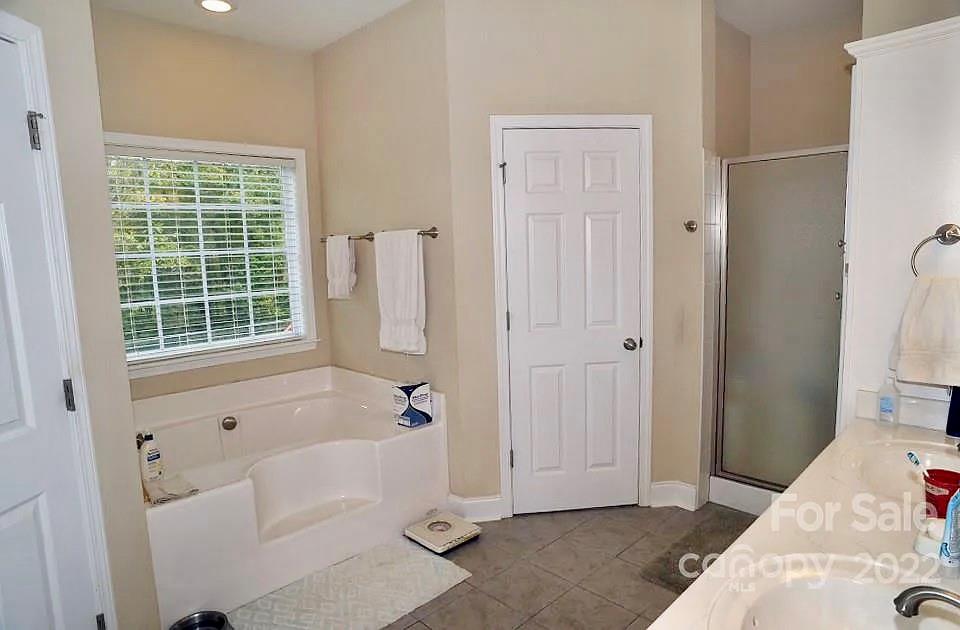 220 Sloan Road Salisbury, NC 28147 - Photo 18 of 30 a bathroom with a bathtub and a shower