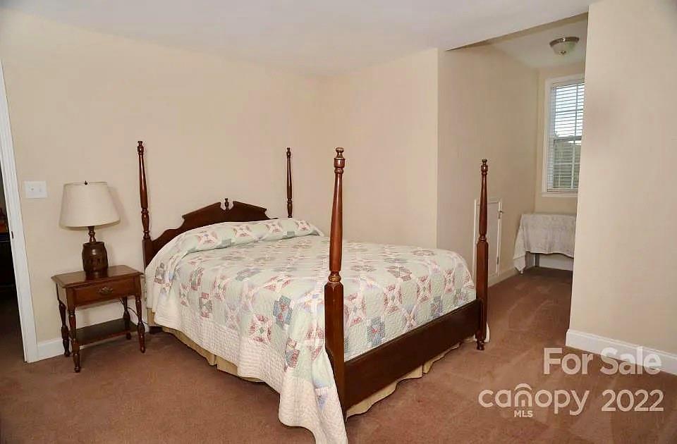 220 Sloan Road Salisbury, NC 28147 - Photo 23 of 30 a bed sitting in a bedroom next to a window