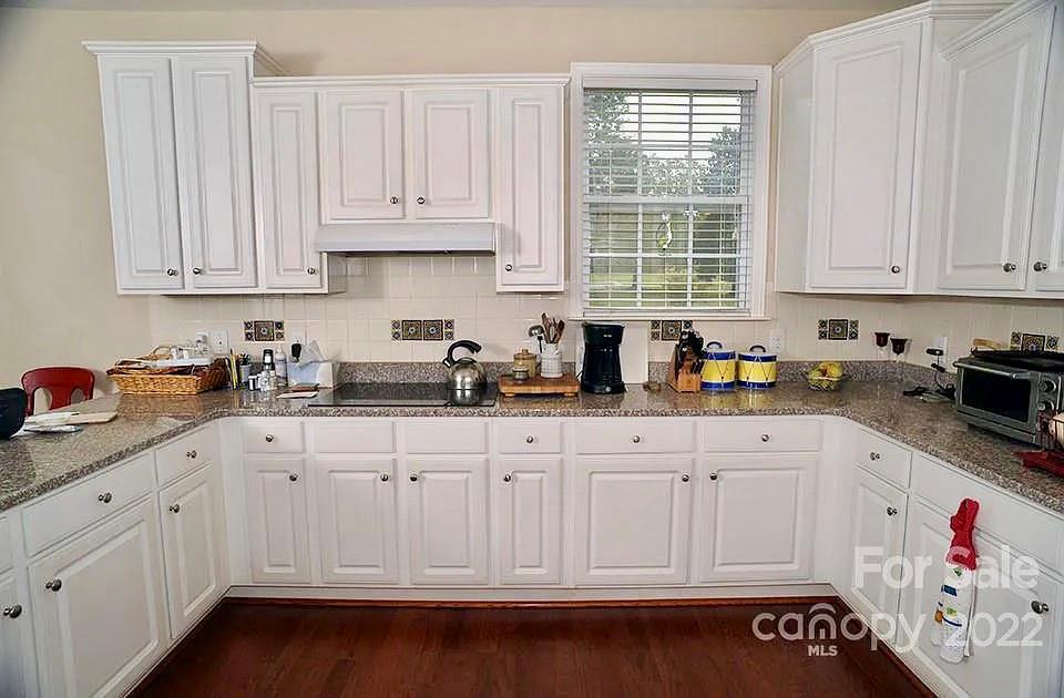 220 Sloan Road Salisbury, NC 28147 - Photo 9 of 30 a kitchen with granite countertop white cabinets and sink