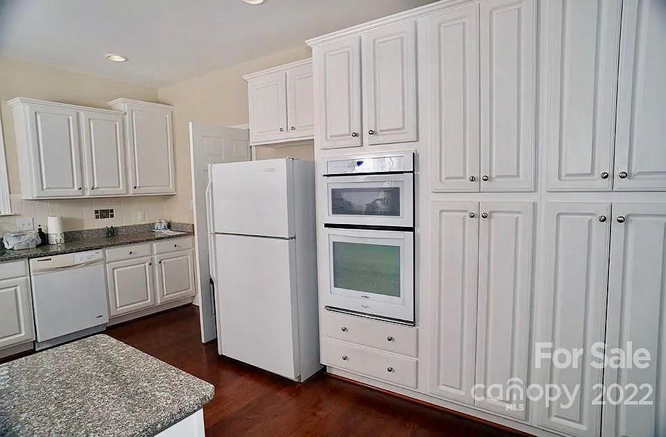 220 Sloan Road Salisbury, NC 28147 - Photo 10 of 30 a kitchen with cabinets and a refrigerator