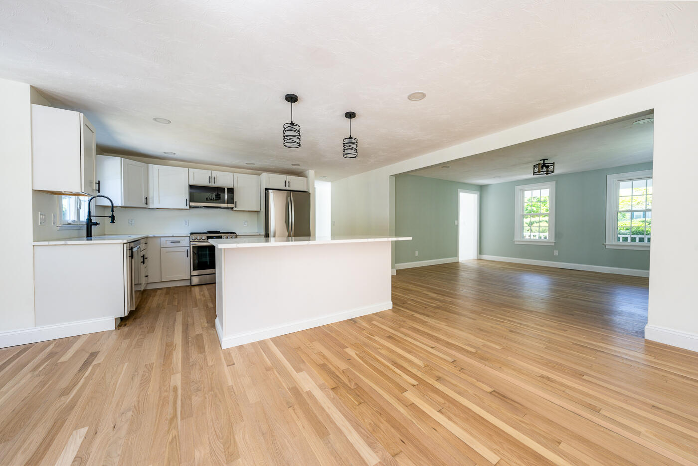83 Whitmar Road Barnstable, MA 02635 - Photo 9 of 27 a view of kitchen with microwave a stove and wooden floor