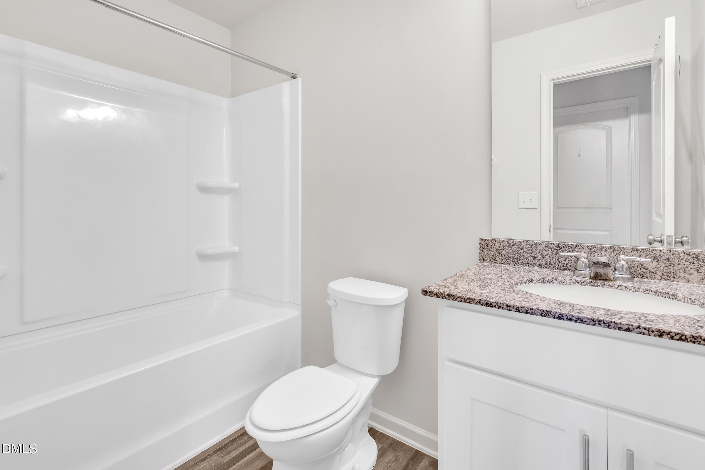 3146 Stoney Hill Church Road Bailey, NC 27807 - Photo 12 of 26 a bathroom with a granite countertop toilet a sink and a bathtub