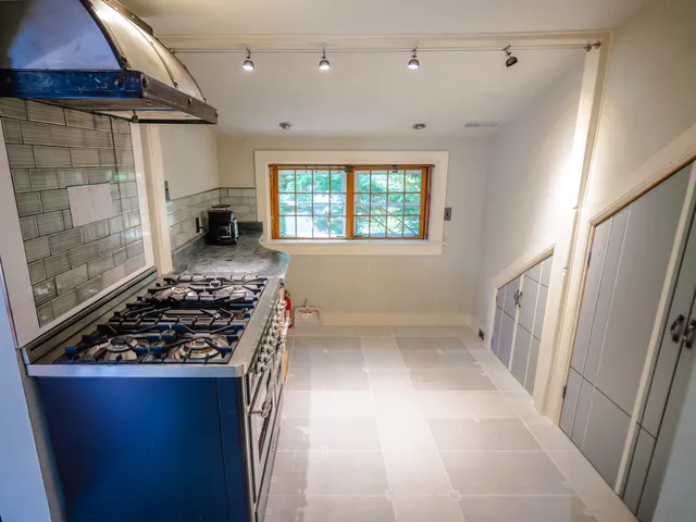 a kitchen with wooden cabinets and a stove