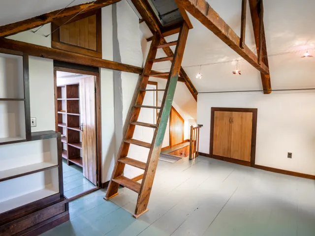 a view of an entryway with wooden floor and door