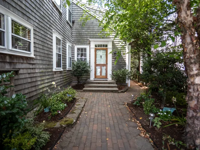 a front view of a house with garden