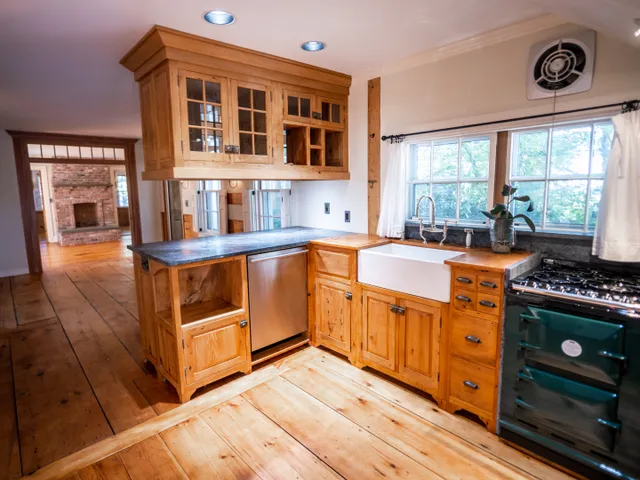 a kitchen with stainless steel appliances a stove a sink and a refrigerator