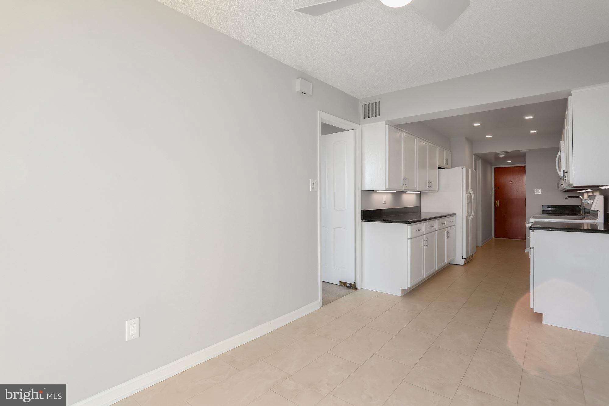 1101 South Arlington Ridge Road, Unit 902 Arlington, VA 22202 - Photo 10 of 38 a kitchen with stainless steel appliances kitchen island sink refrigerator and cabinets