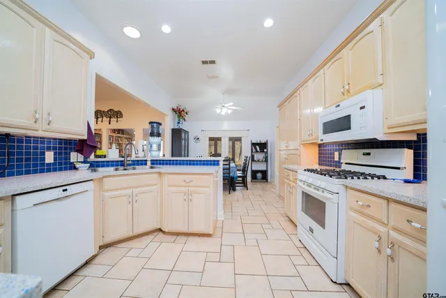 a bedroom with bed and a chandelier