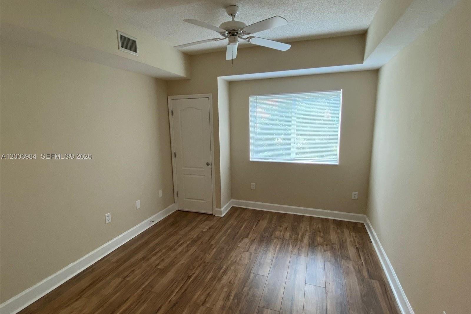 6001 Southwest 70th Street, Unit 342 South Miami, FL 33143 - Photo 14 of 19 an empty room with a window and a fan