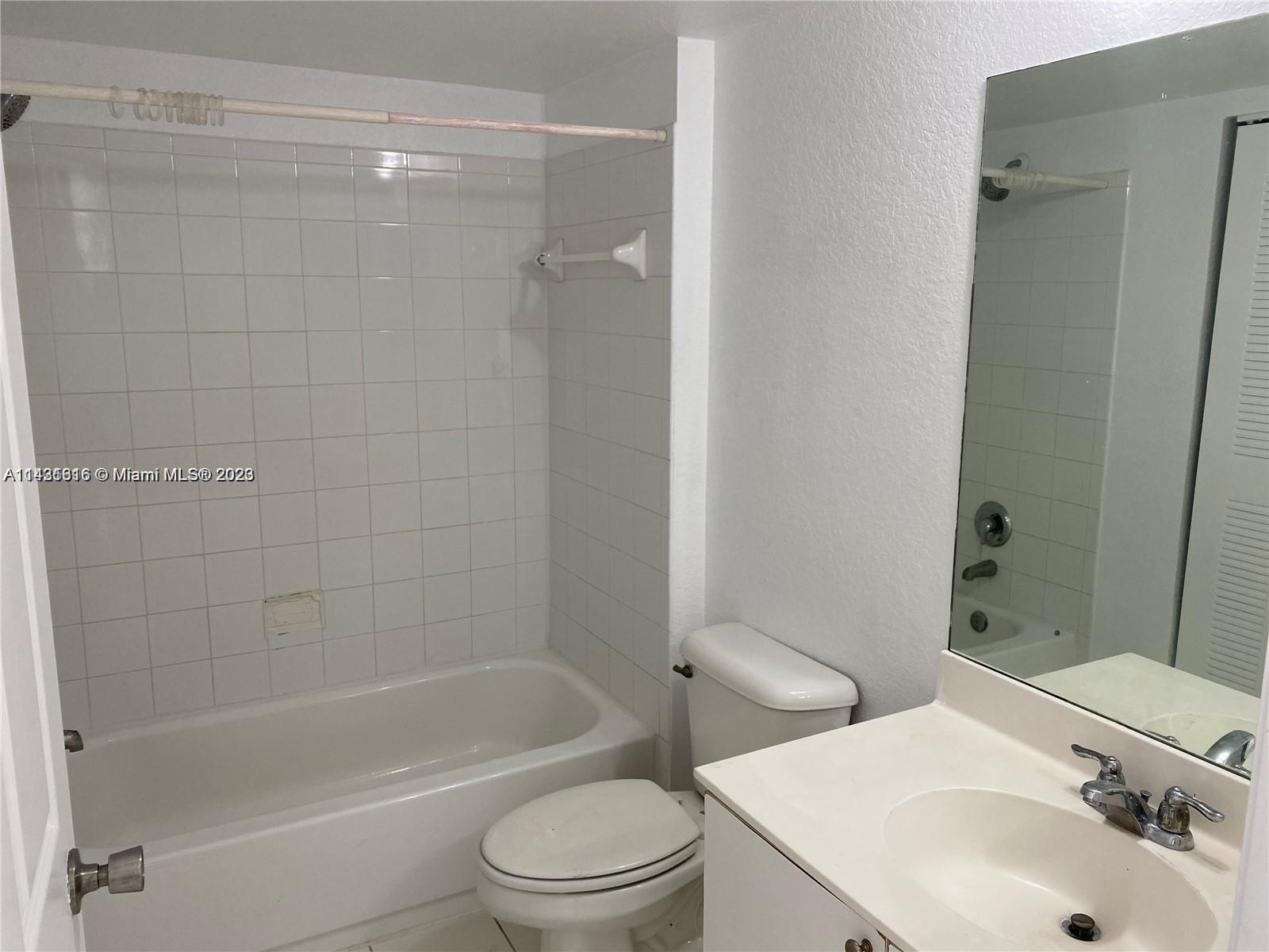 15440 Southwest 284th Street, Unit 5307 Homestead, FL 33033 - Photo 3 of 7 a bathroom with a bathtub shower sink vanity and toilet