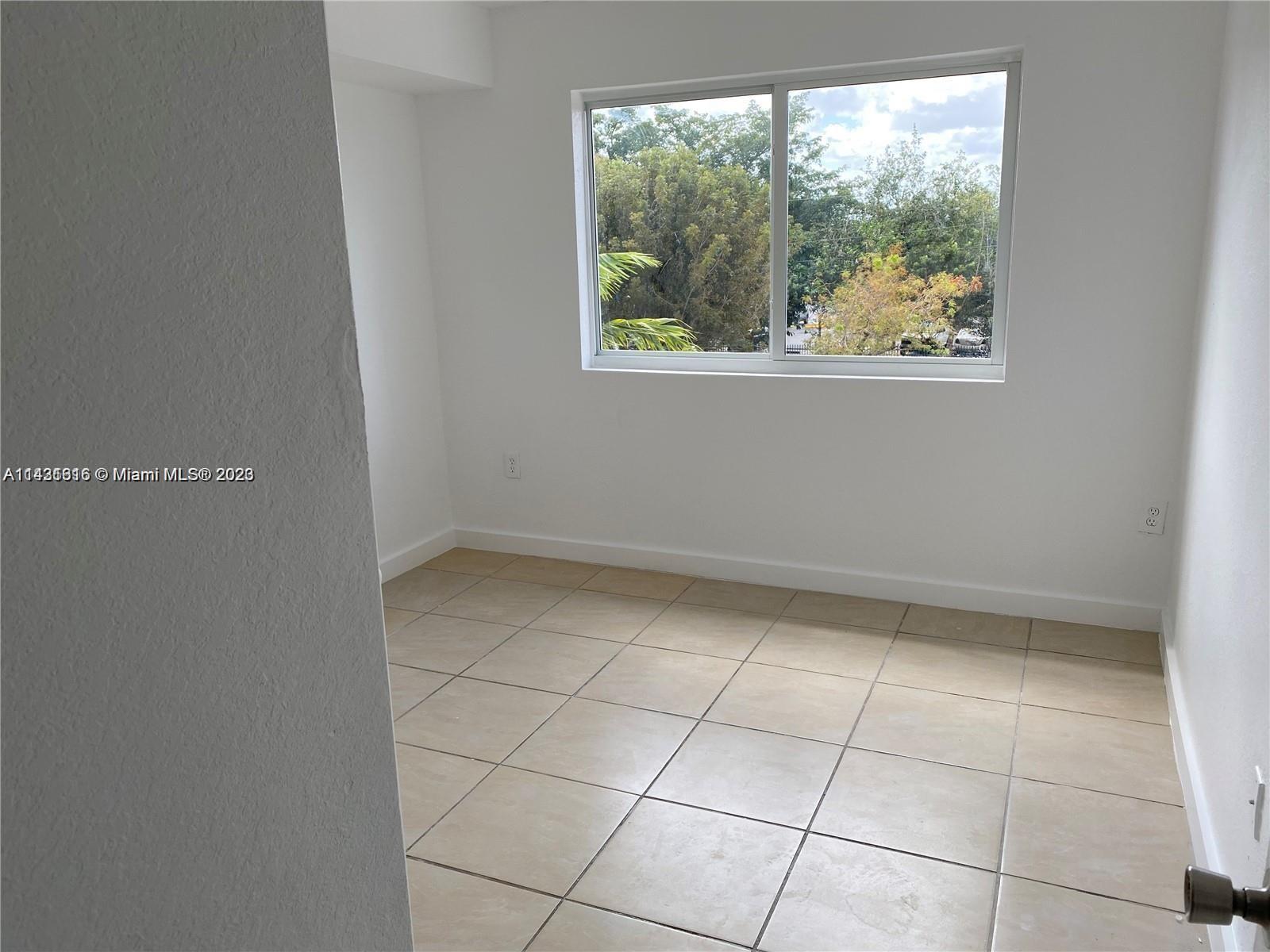 15440 Southwest 284th Street, Unit 5307 Homestead, FL 33033 - Photo 4 of 7 a view of an empty room with a window