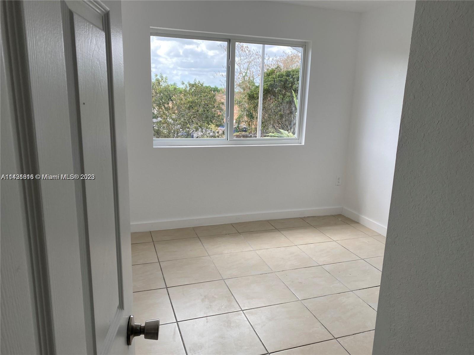 15440 Southwest 284th Street, Unit 5307 Homestead, FL 33033 - Photo 5 of 7 a view of an empty room with a window