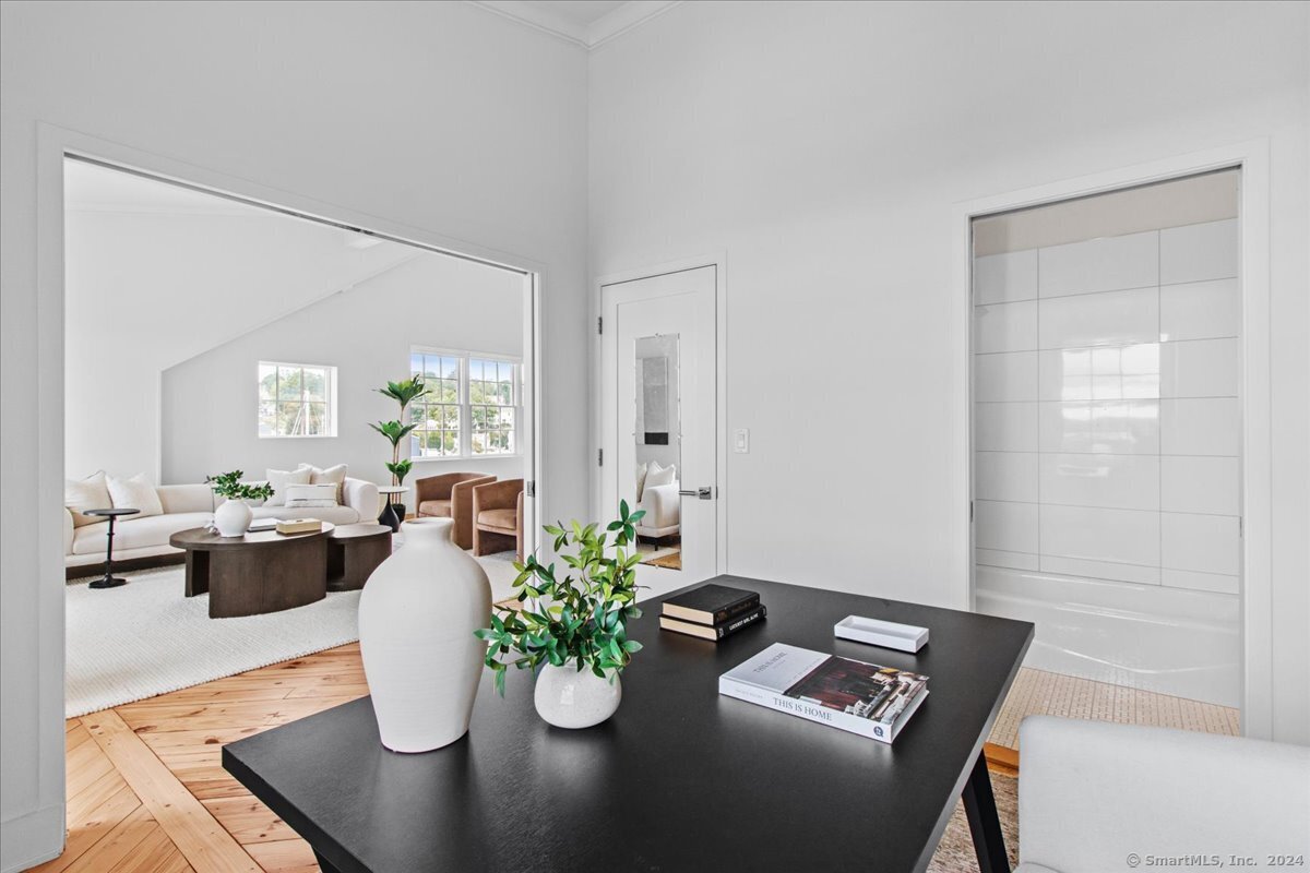 60 Willow Street, Unit 305 Stonington, CT 06355 - Photo 15 of 21 a view of a dining room with furniture and a potted plant