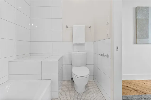a bathroom with a toilet and a shower
