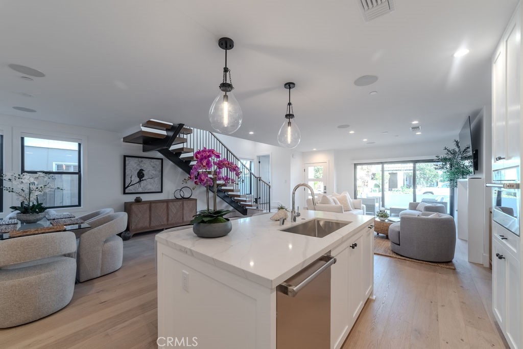 603 Acacia Avenue, Unit A Corona del Mar, CA 92625 - Photo 11 of 53 a view of a kitchen with kitchen island stainless steel appliances a sink and living room view