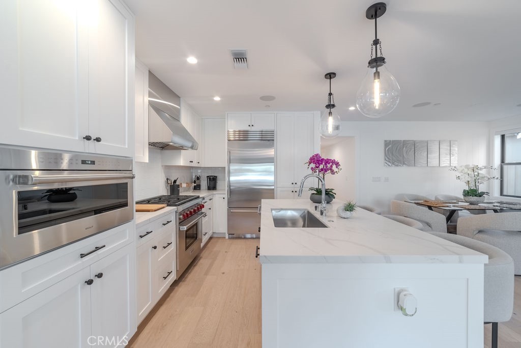 603 Acacia Avenue, Unit A Corona del Mar, CA 92625 - Photo 12 of 53 a kitchen with stainless steel appliances a sink stove top oven and microwave