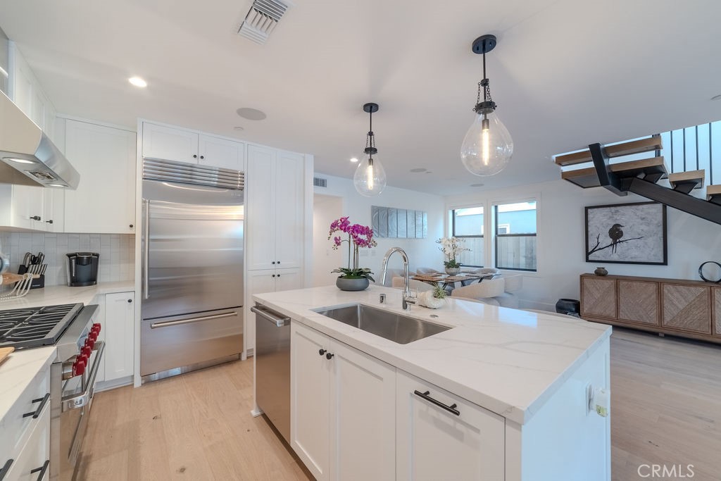 603 Acacia Avenue, Unit A Corona del Mar, CA 92625 - Photo 13 of 53 a kitchen with sink cabinets and stainless steel appliances