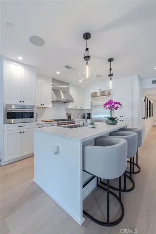 a kitchen with granite countertop a sink cabinets and window
