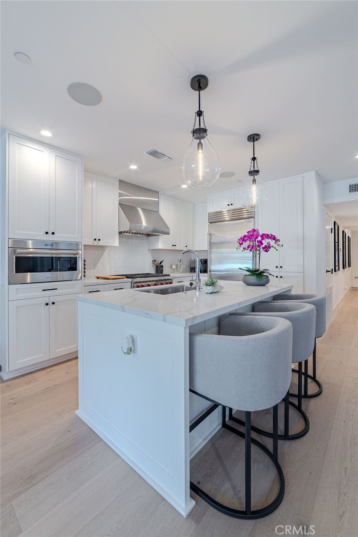 603 Acacia Avenue, Unit A Corona del Mar, CA 92625 - Photo 15 of 53 a kitchen with granite countertop a sink cabinets and window